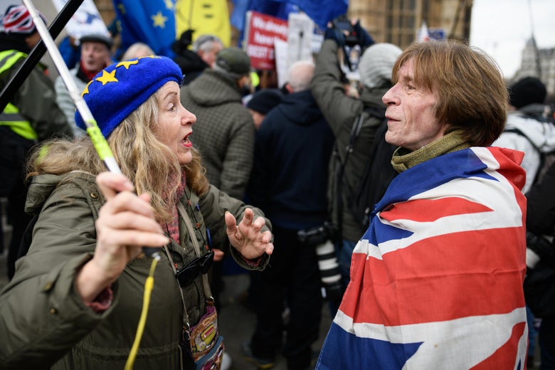 Pro-EU and pro-Brexit protesters discuss the vote and ongoing political processes as they demonstrate near to the Houses of Parliament on Tuesday in London.